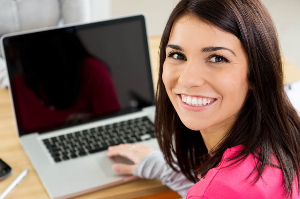 happy student in front of laptop